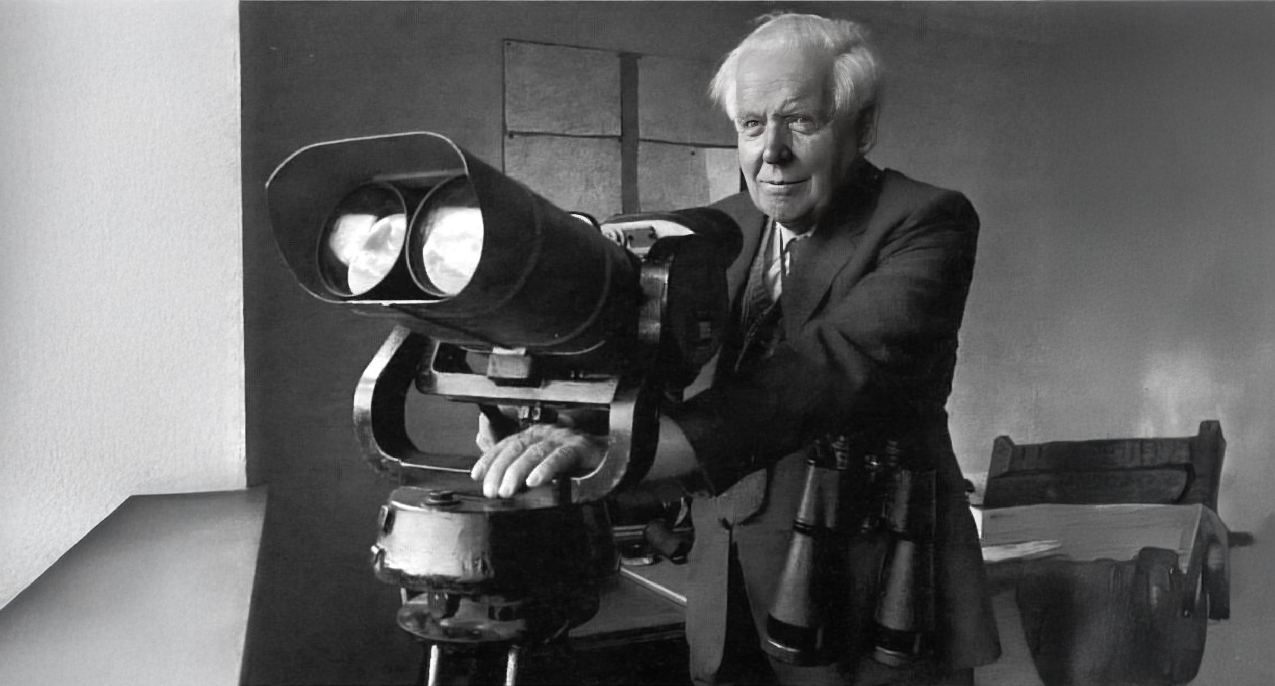 George Alcock looking through large astronomical binoculars